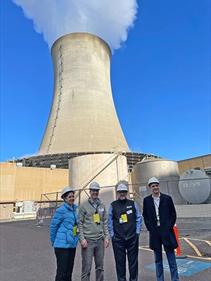 DRBC staff pose for a photo with one of Limerick's cooling towers. Photo courtesy of Constellation Energy.