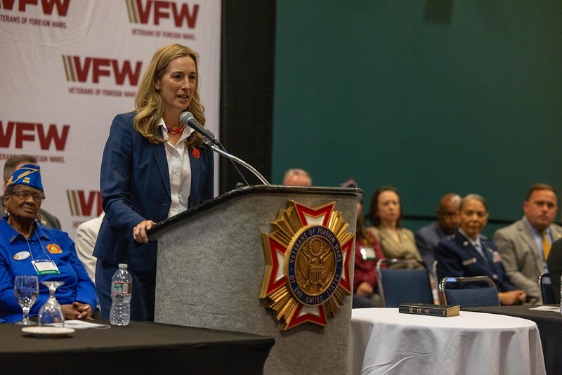 Governor Mikie Sherrill in front of the podium speaking at the Department of New Jersey Veterans of Foreign Wars Annual Convention. 