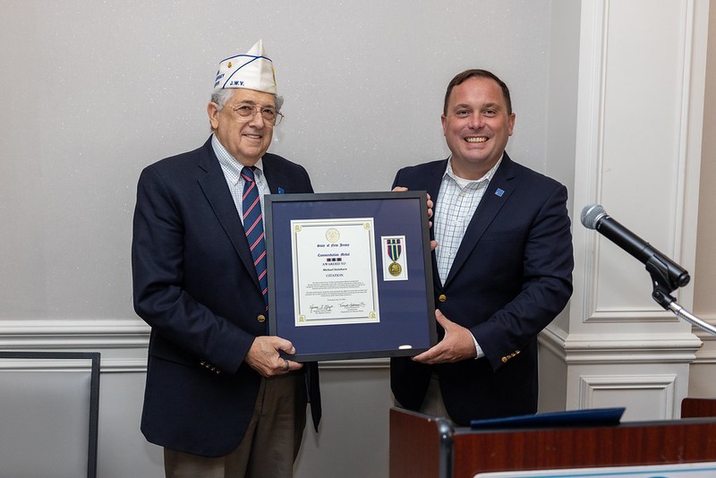Commissioner Vincent Solomeno presents Jewish War Veterans Department of New Jersey Commander Michael Steinhorn with the New Jersey Commendation Medal.