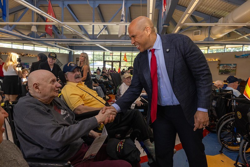 Senator Cory Booker shakes hands with a veteran at the ceremony