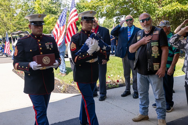 Two U.S. Marine Honor Guards performing dignified transfer of veteran's cremains to the Brigadier General William C. Doyle Veterans Memorial Cemetery.