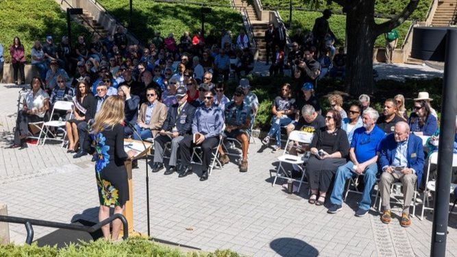 Deputy Commissioner Esther Chucaralao sitting in attendance at the In Memory ceremony for Vietnam War Veterans at the New Jersey Vietnam Veterans Memorial and Museum in Holmdel.