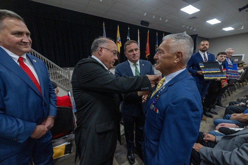 One of the 100 veterans being pinned the state service medal.