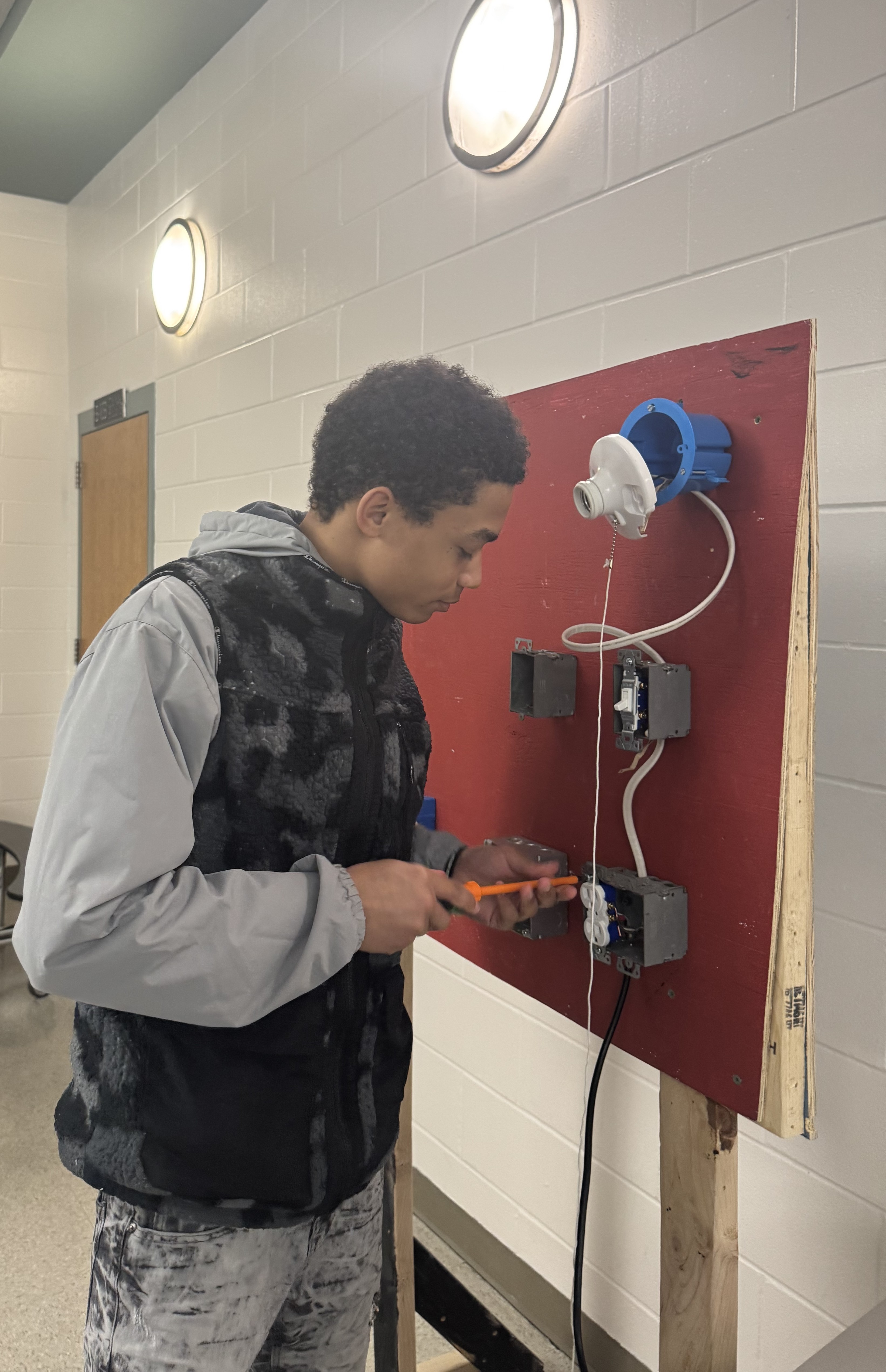 student working with screw driver