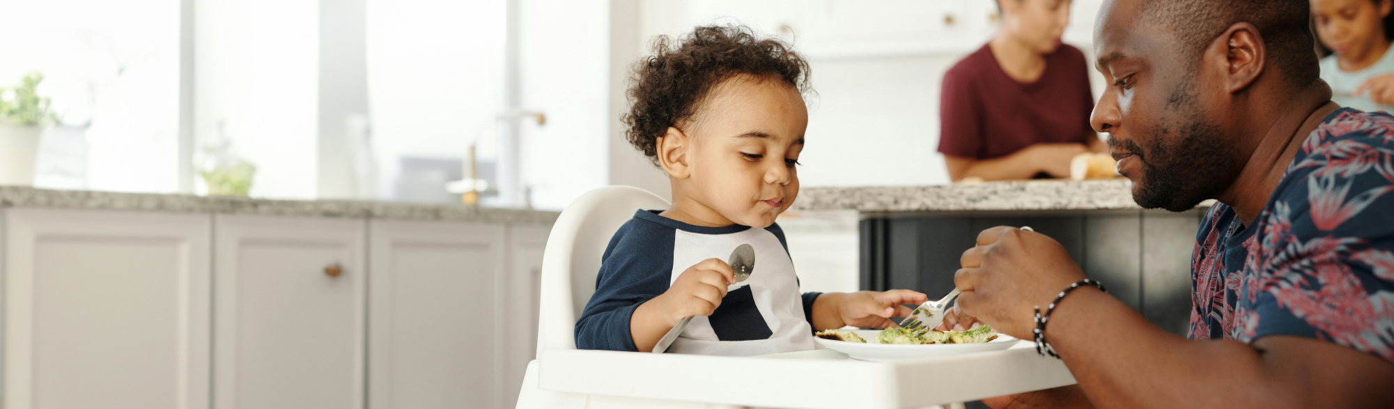 Family sharing food together in a kitchen