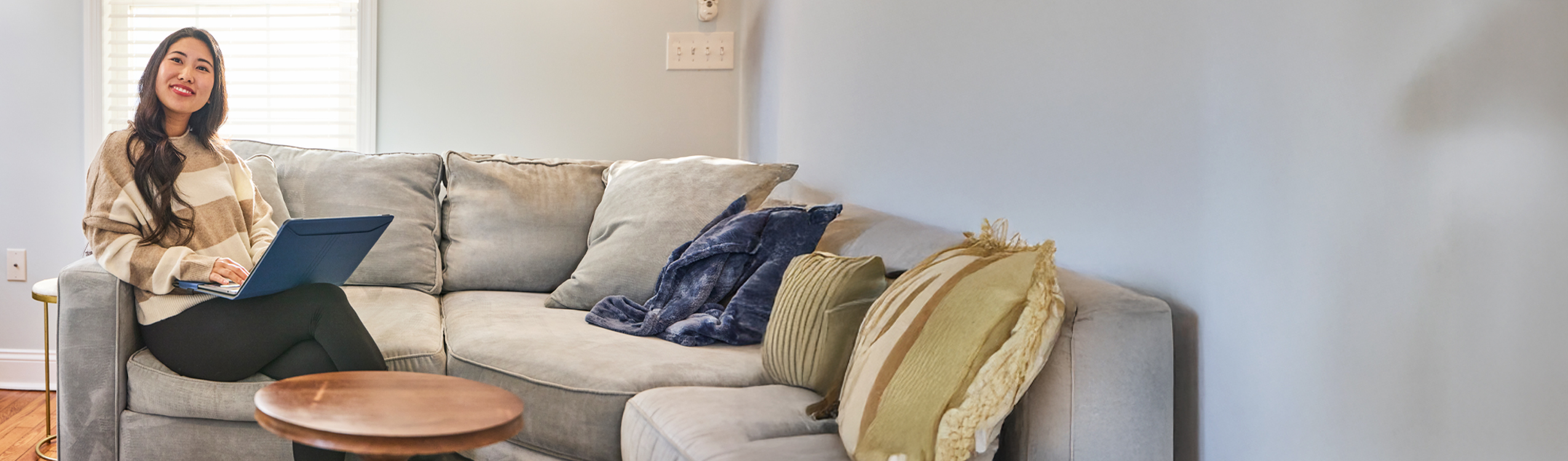 photo: woman with laptop on couch
