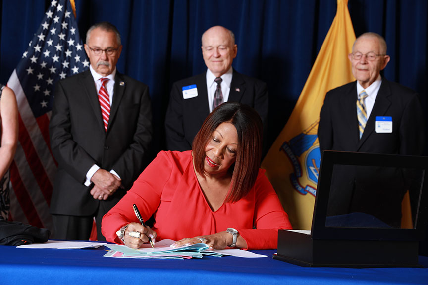 Acting Governor Oliver Signing Bill
