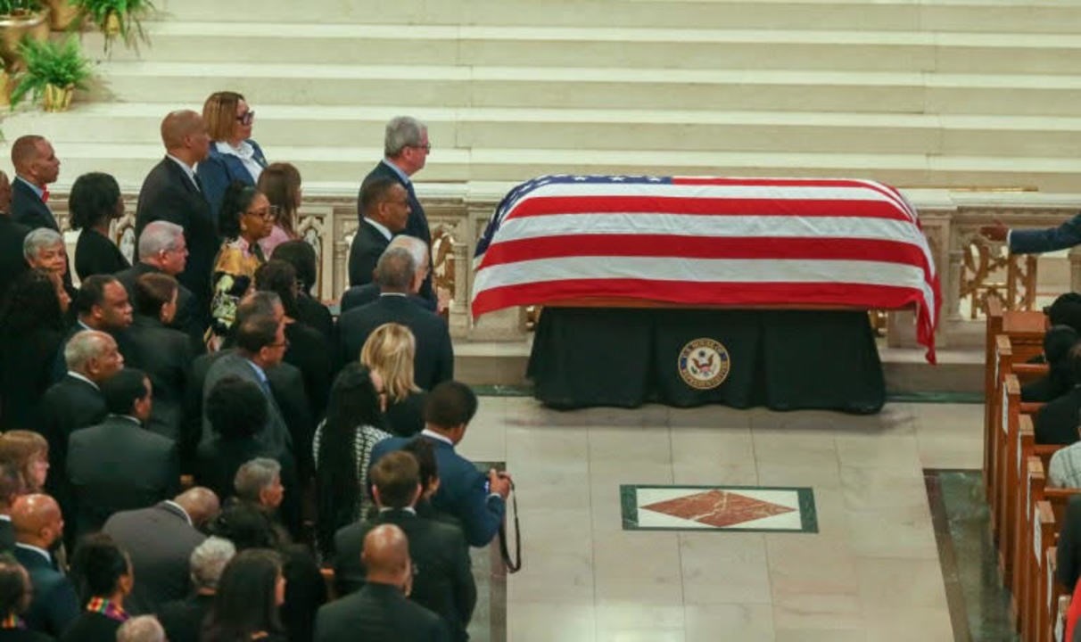 Photo: Governor Murphy and other standing in front of U.S. Congressman Donald M. Payne, Jr. coffin