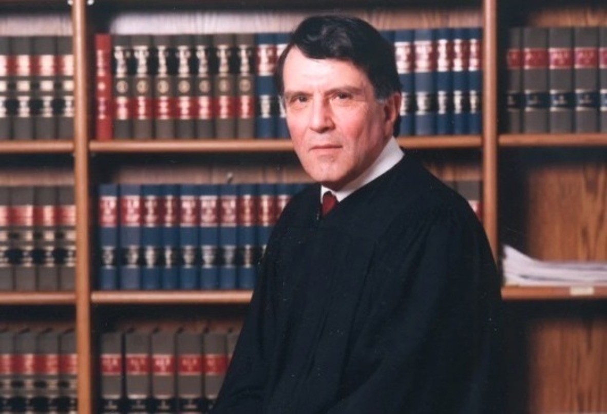 Photo: Justice Alan B. Handler with shelves of books on the background