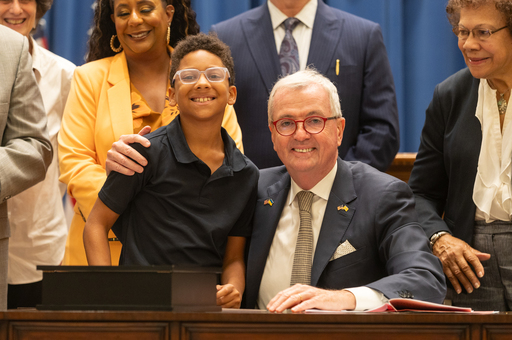 Governor Murphy smiling next to a young boy