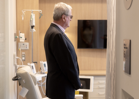 Governor Murphy is looking on the painting in the hospital room