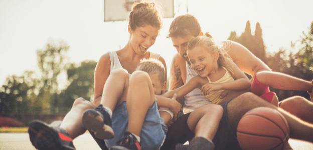 A family embracing on a basketball court.