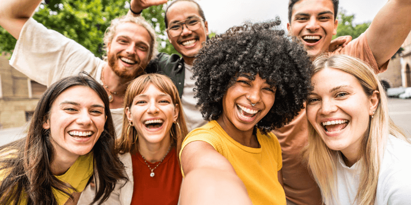 Image of a group of people smiling.