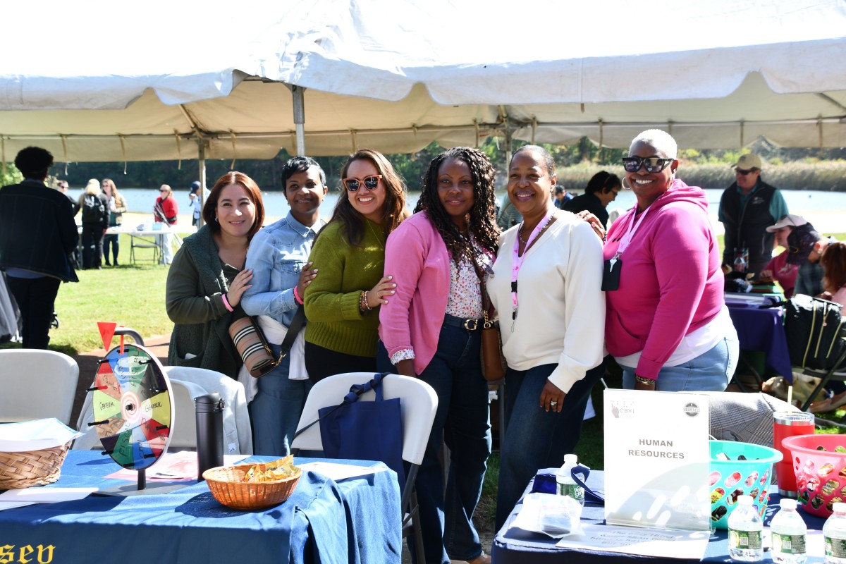 People posing for a picture at the picnic outside