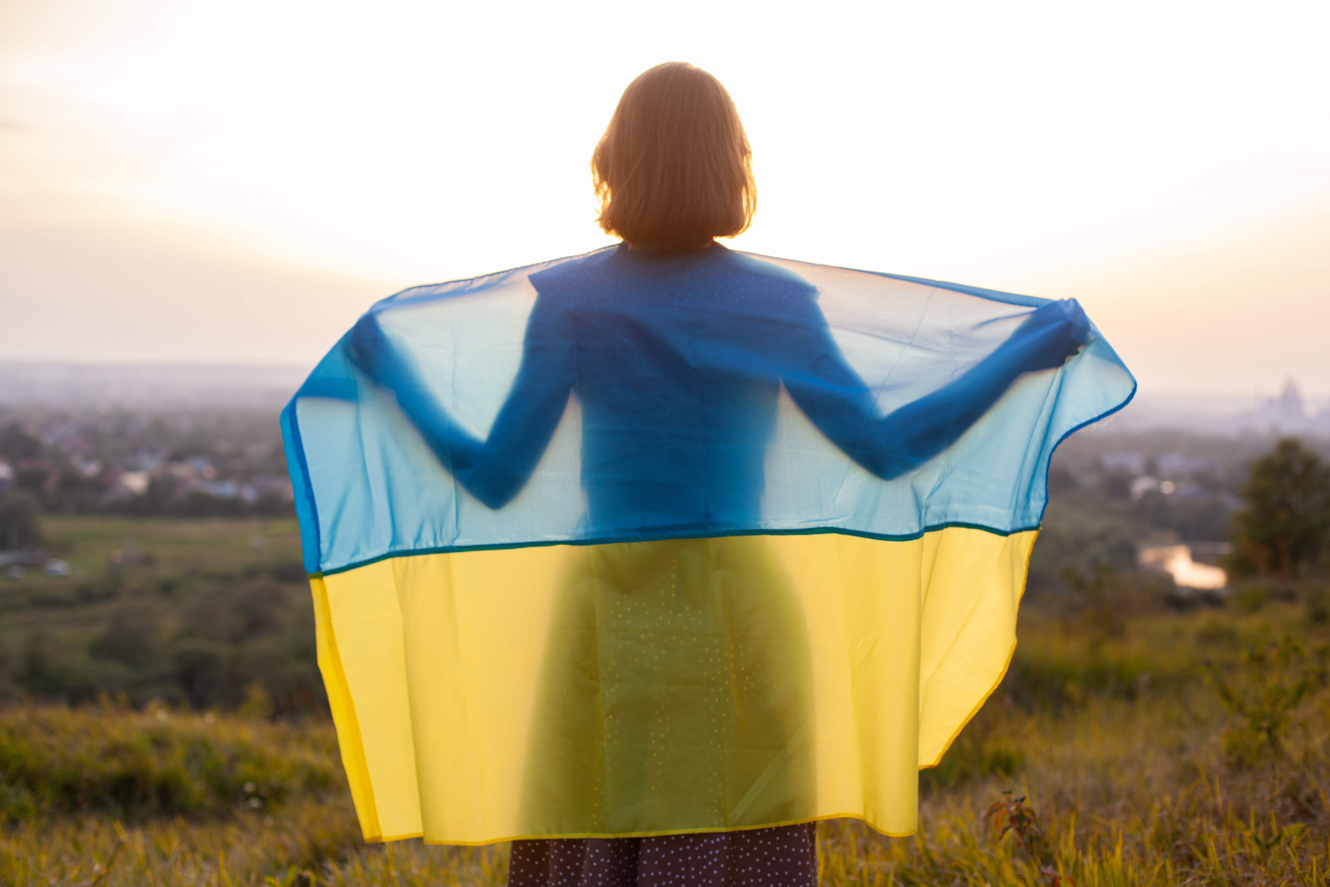 a person holhing ukraine flag