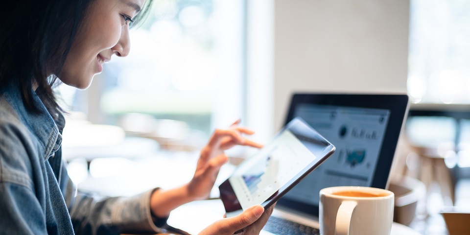 woman at cafe on tablet