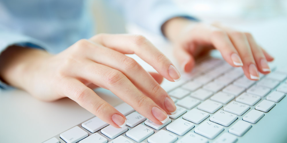 a woman typing on a keyboard