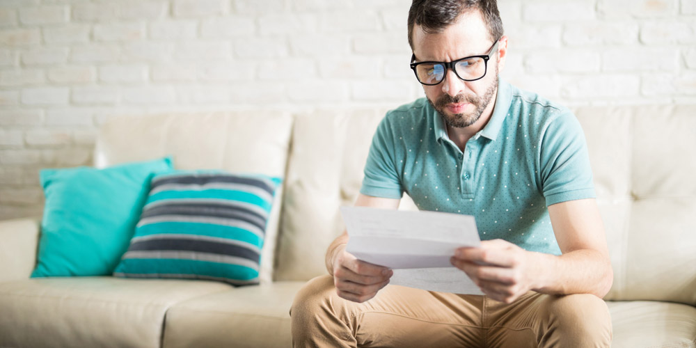 man looking at paper