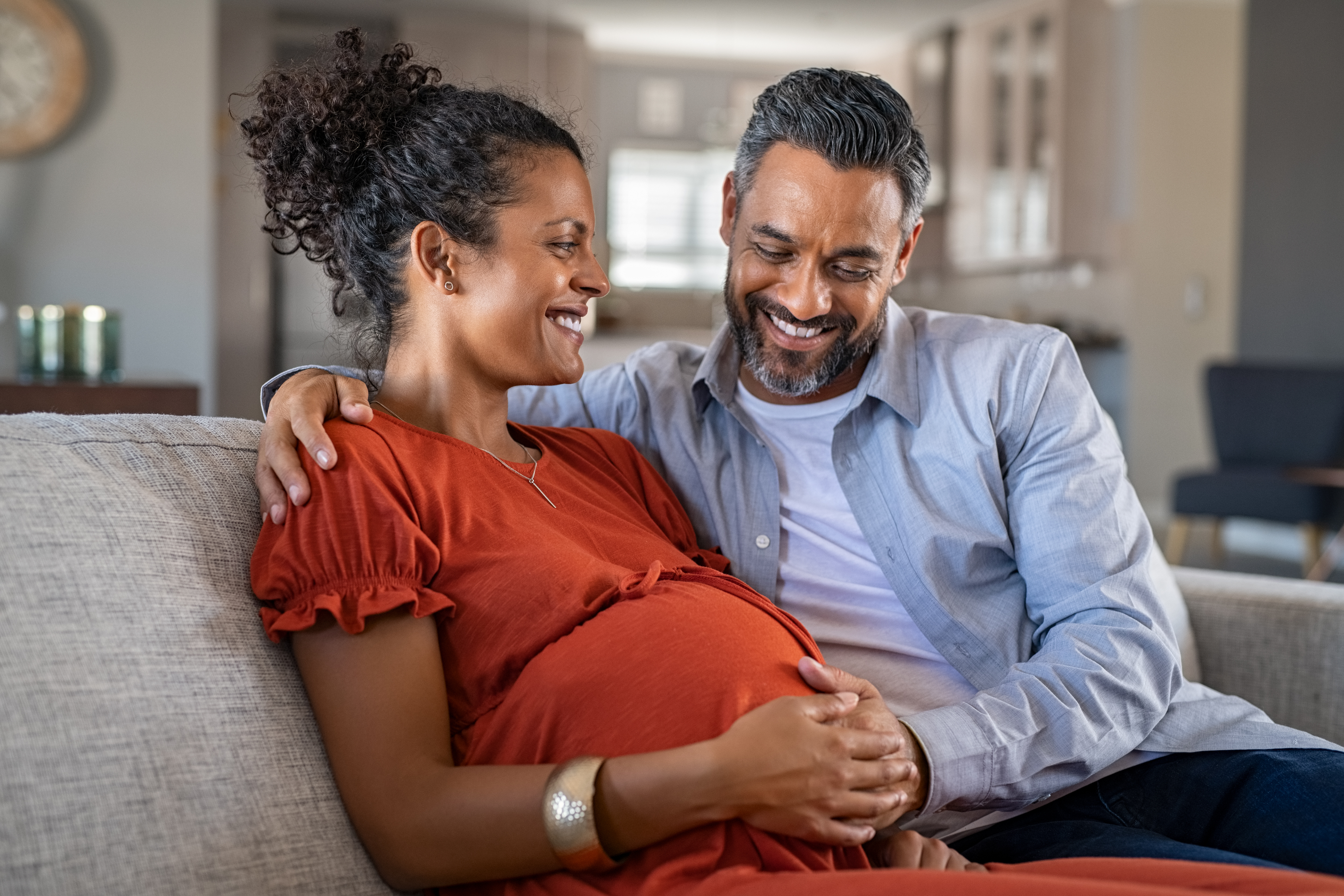 pregnant woman and husband on couch