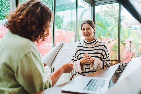 a woman showing a career counselor her resume