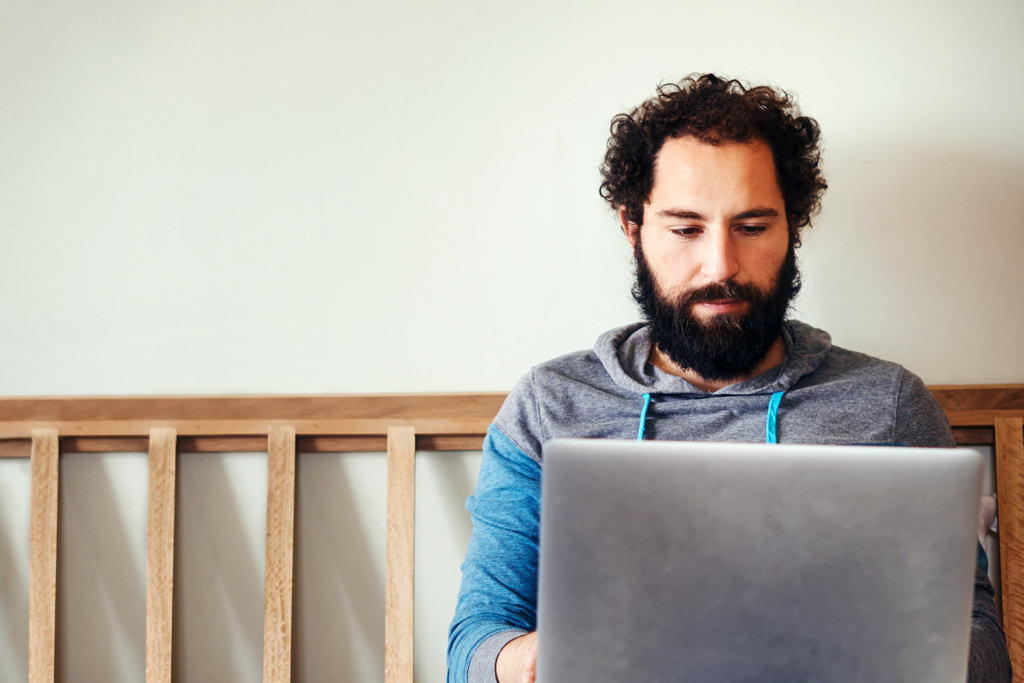 man looking at a laptop computer