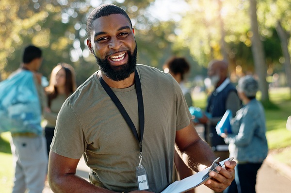 man standing outside holding clipboard