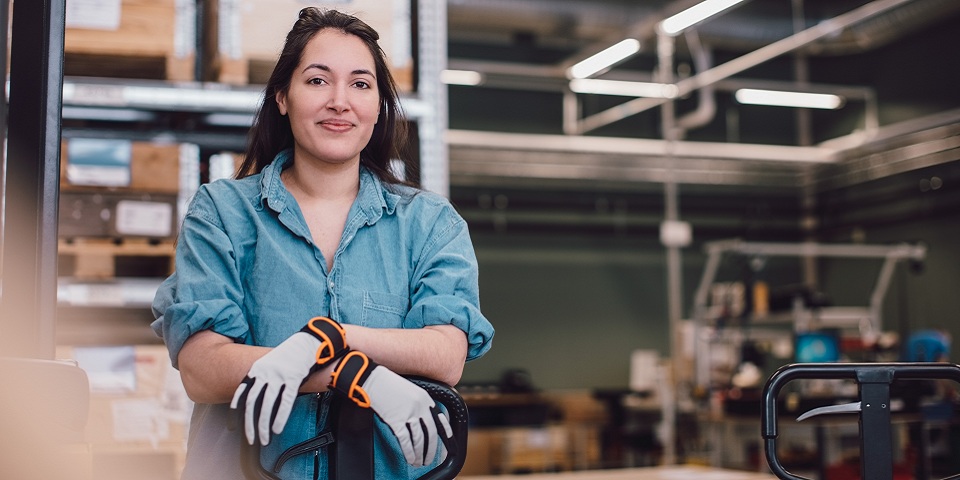 Female worker smiling at warehouse