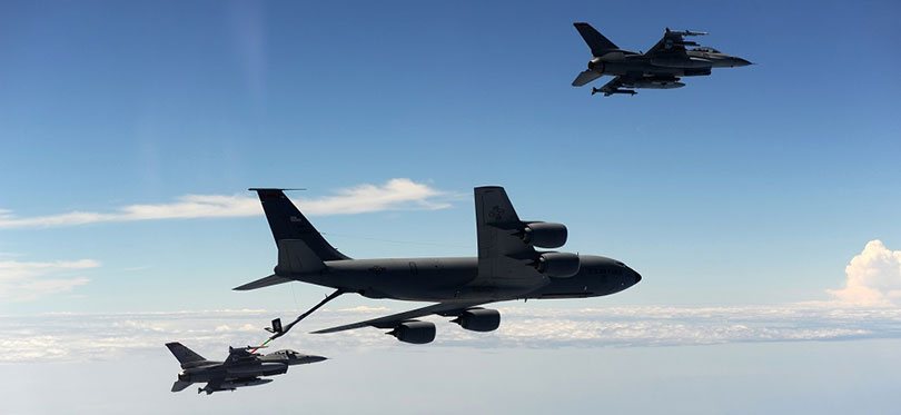A KC-135 Stratotanker refueling a F-16 Falcon in mid-air.