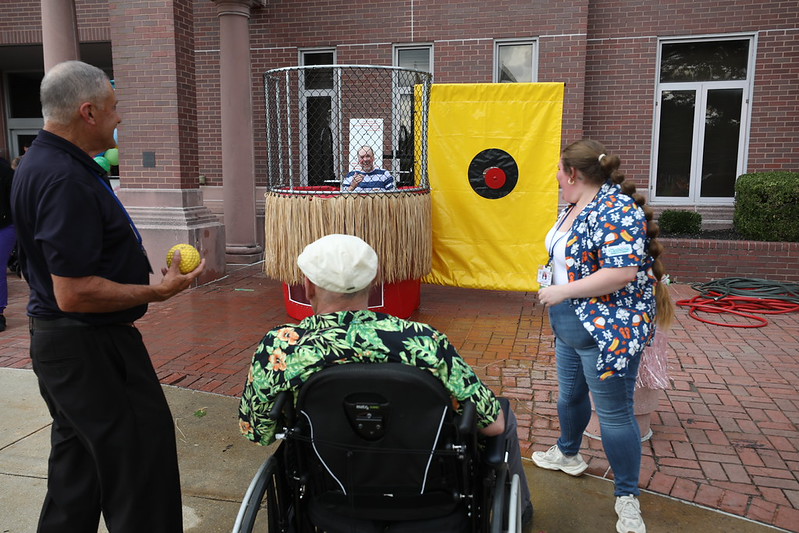 Vineland staff member getting dunked in the dunk tank at the home's end-of-summer luau
