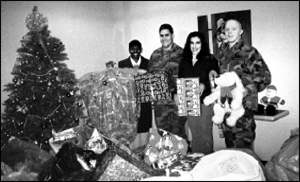 L-R: Adela Lopez, Family Group Conference Coordinator, Children's Home Society of NJ; Staff Sgt. Arthur Joseph Valenzuela-Bradley, Florence Paric, Director of Administrative Services, CHSNJ; and Pfc. James Malwitz stand in front of the toys collected for the children.  Photo courtesy of Staff Sgt. Arthur Jospeh Valenzuela-Bradley.