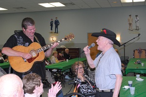 A resident singing in the Auditorium at Vineland Memorial Home