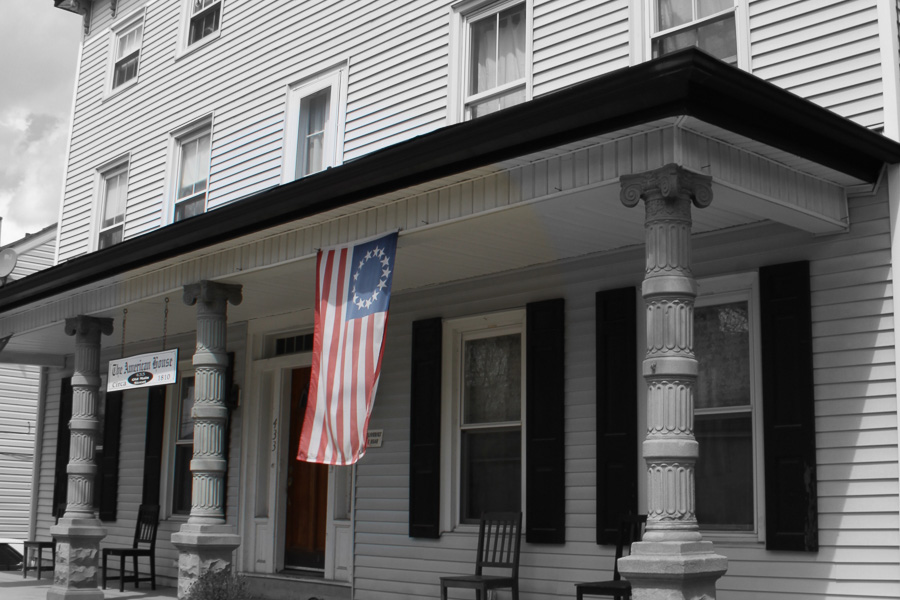 white building with american flag hanging