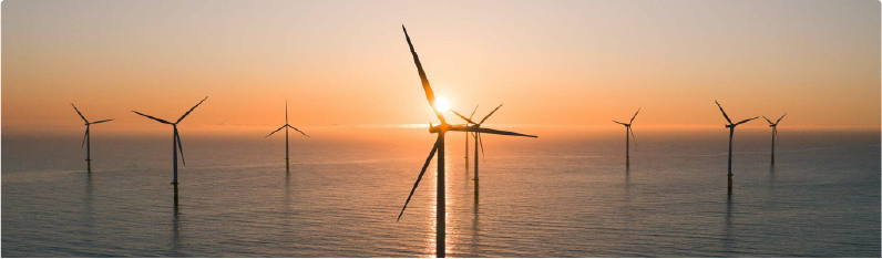 wind turbines in ocean during sunrise