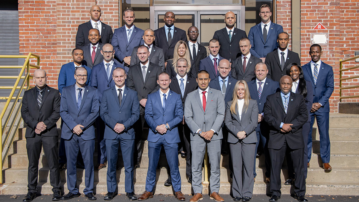 photo: three rows of parole members standing on the front steps