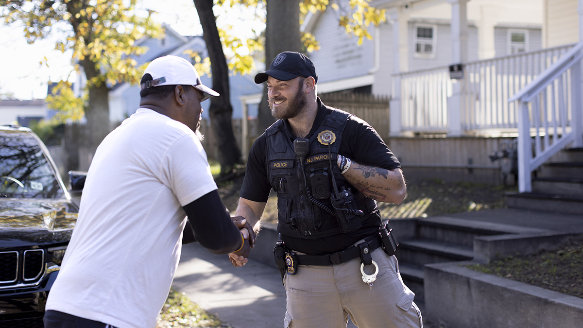 photo: parole offices shaking hands with a community member