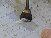 The tape is meticulously removed using a heated spatula