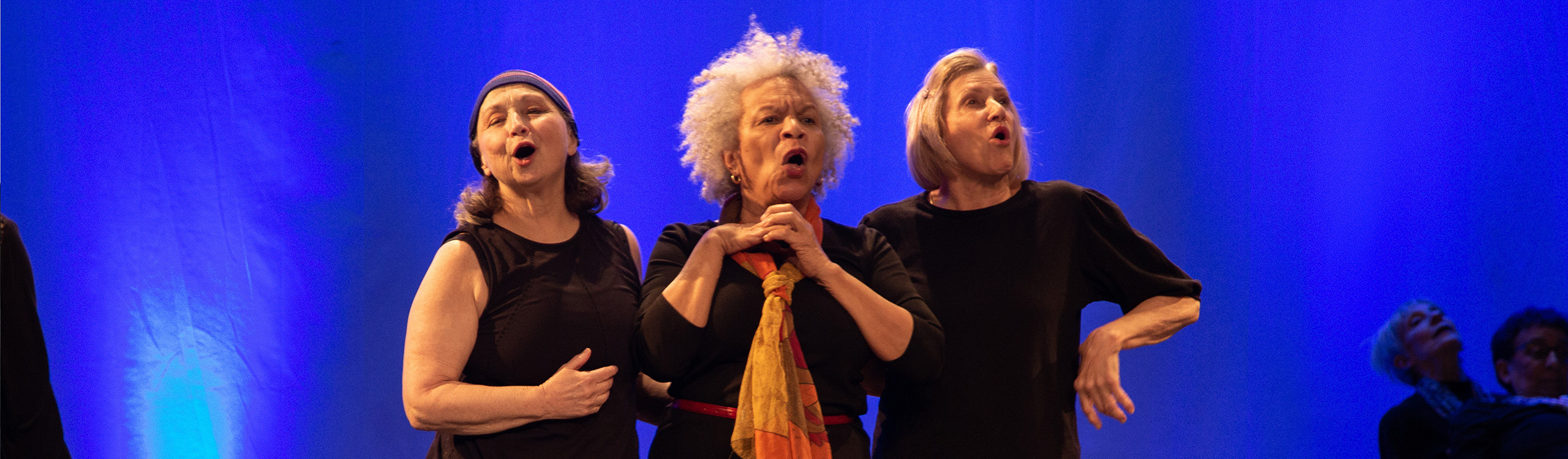 three older adults performing a modern dance