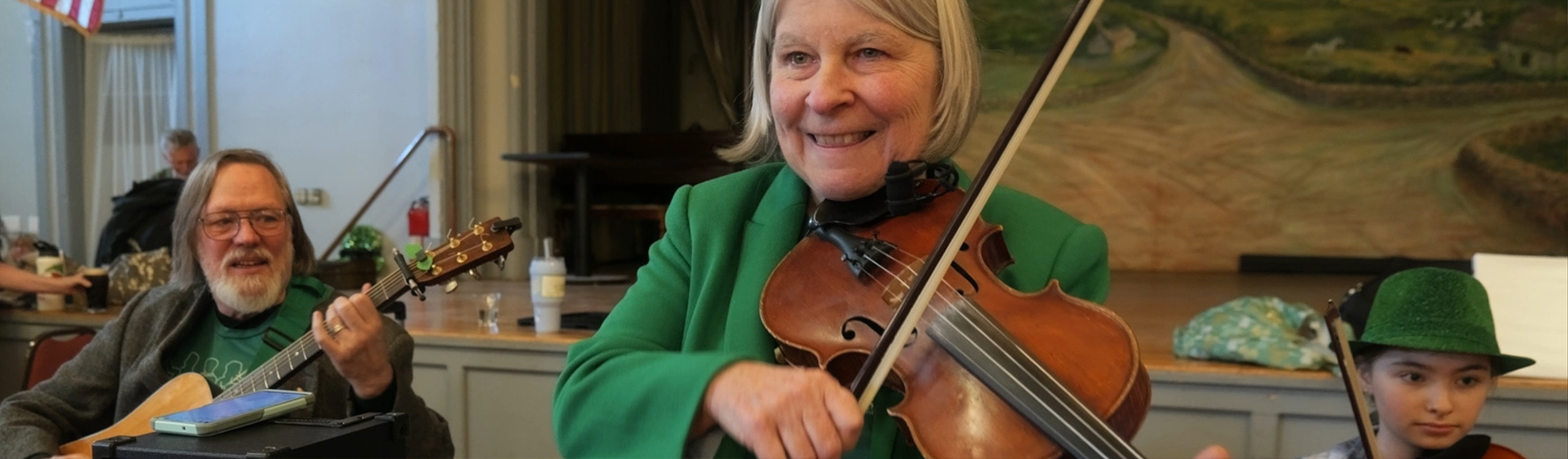 three musicians playing violin and guitar