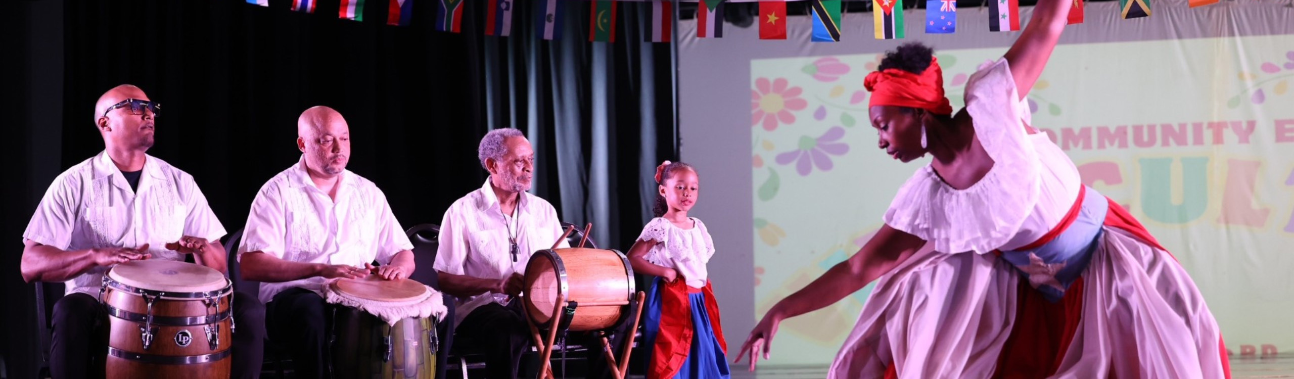 percussionists and dancers perform onstage