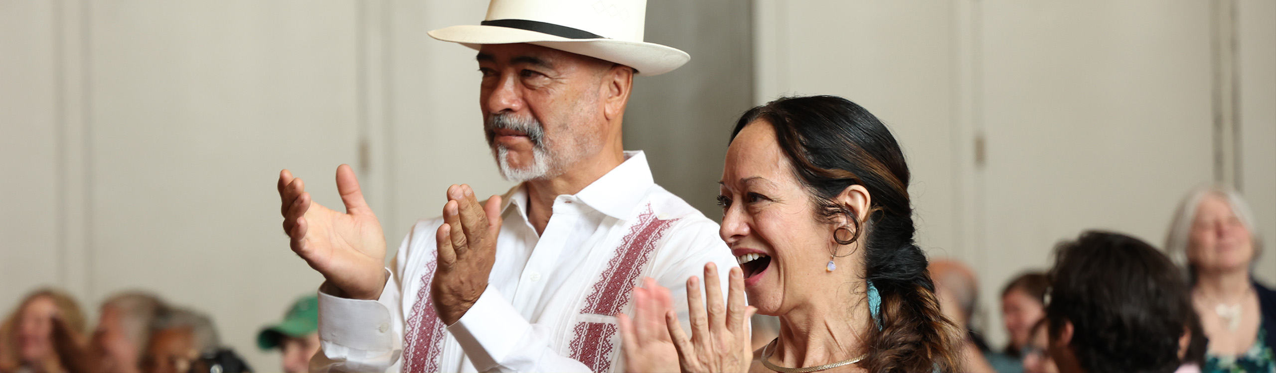two artists applauding at a state arts council public meeting