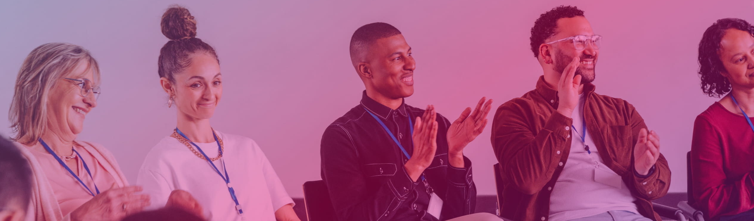 five people sitting next to each other at a conference