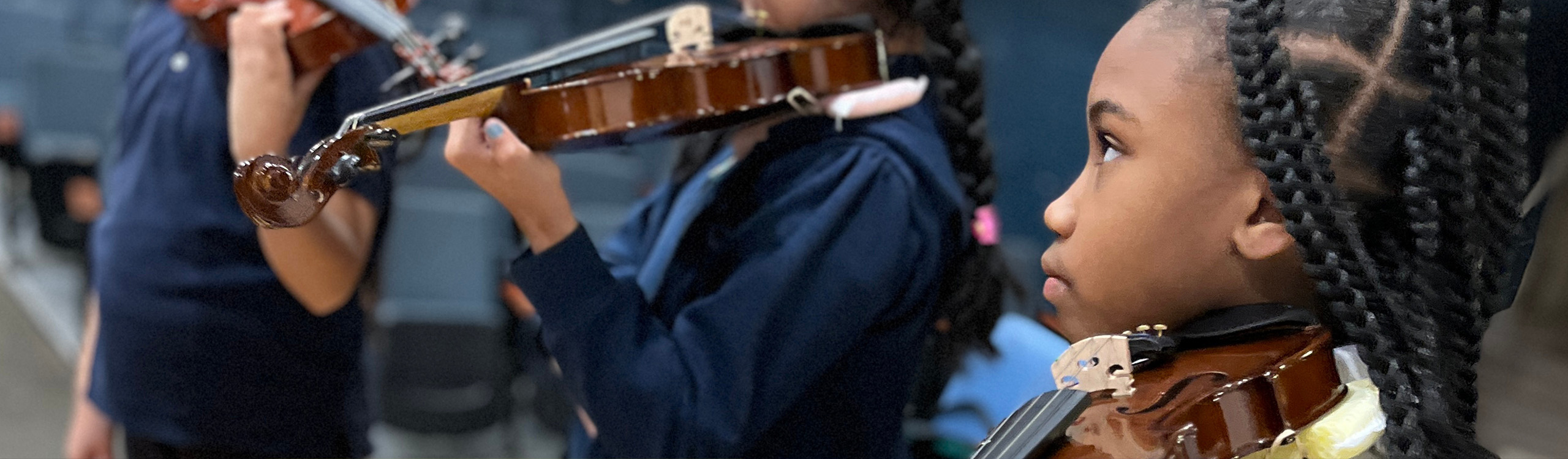 young students playing their violins