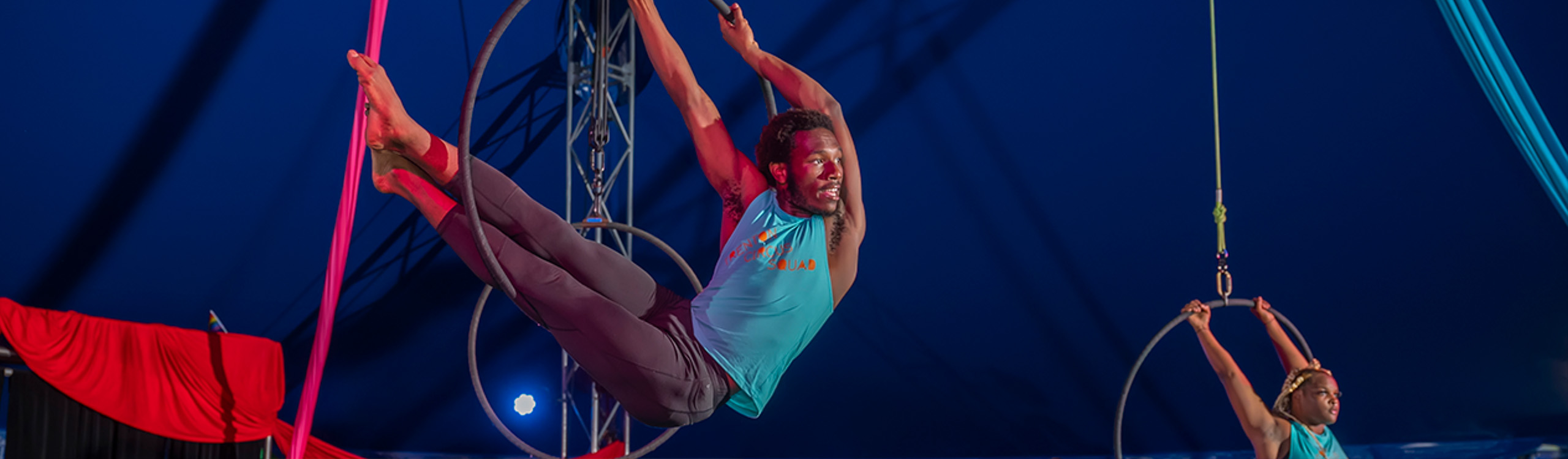 two circus performers doing aerial maneuvers