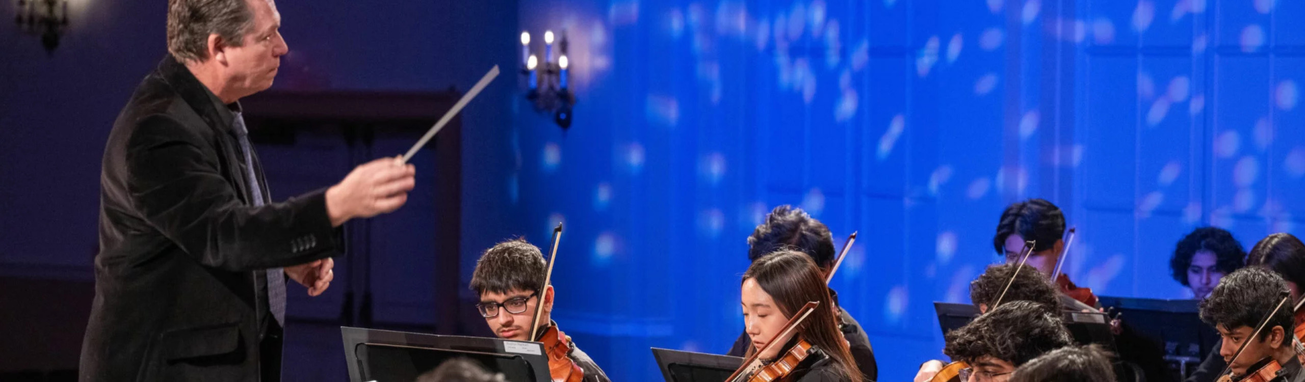 conducter leads youth orchestra