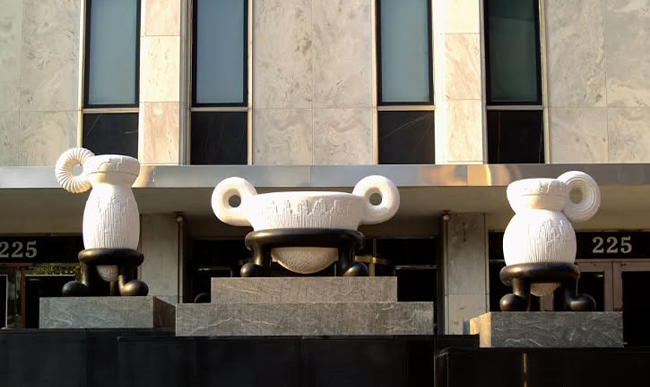 Three sculptures in front of a building