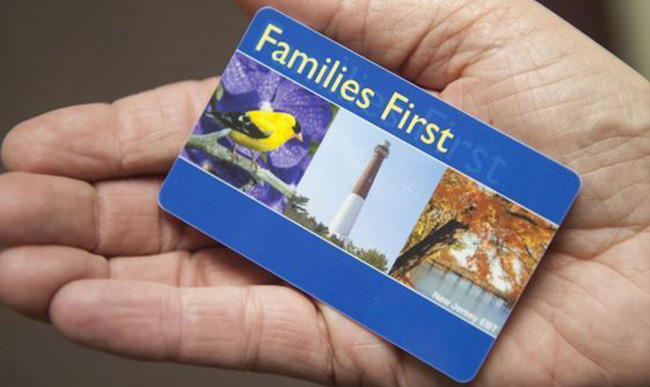 An open hand holding a Families First Discovery Pass card
