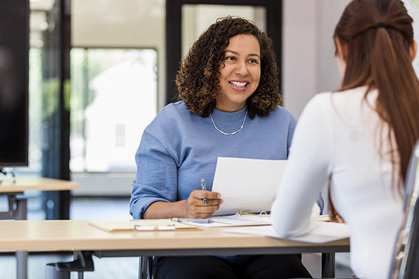 woman reading resume at job fair